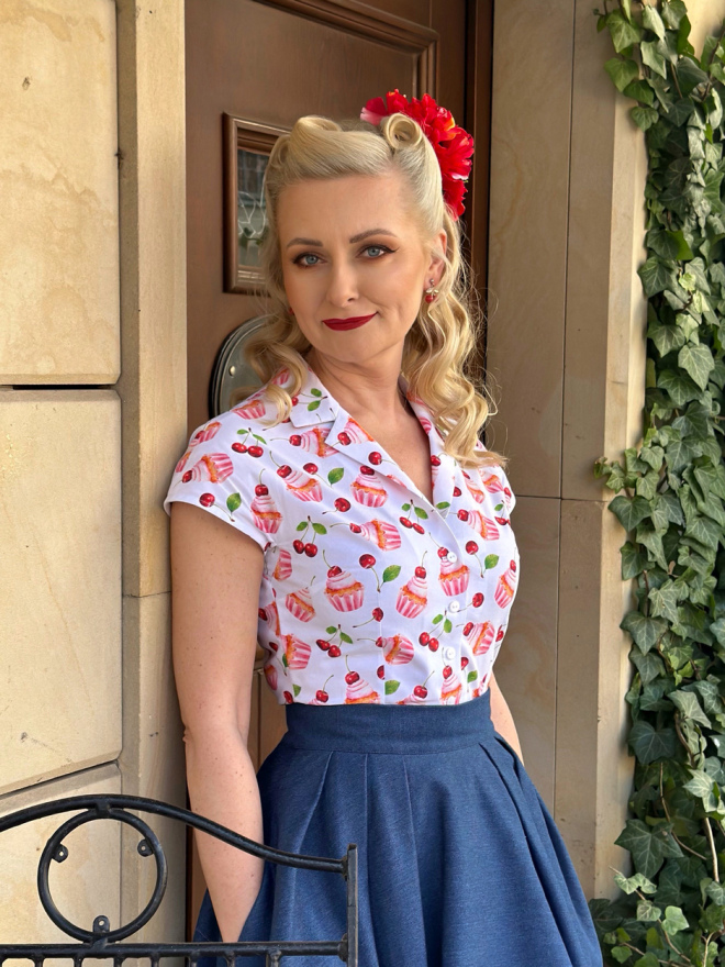 Bluzka Peggy w stylu pin-up z kołnierzem wykładanym, krótkimi kimonowymi rękawami i wzorem babeczek oraz wiśni na białym tle.